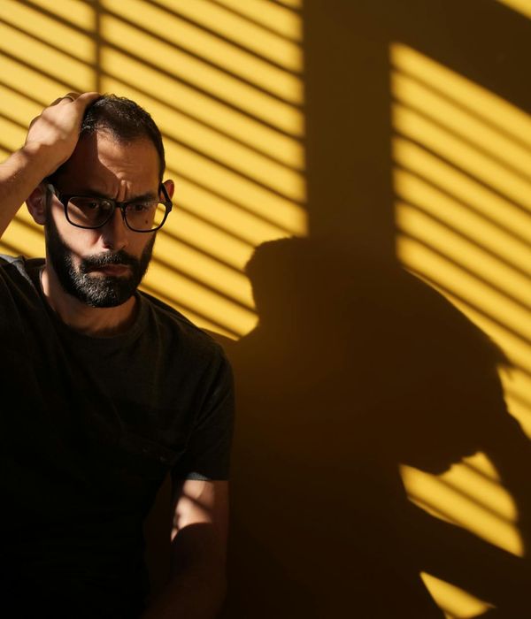 Silhouette of a man meditating with a focused expression, neon lines representing mental clarity.